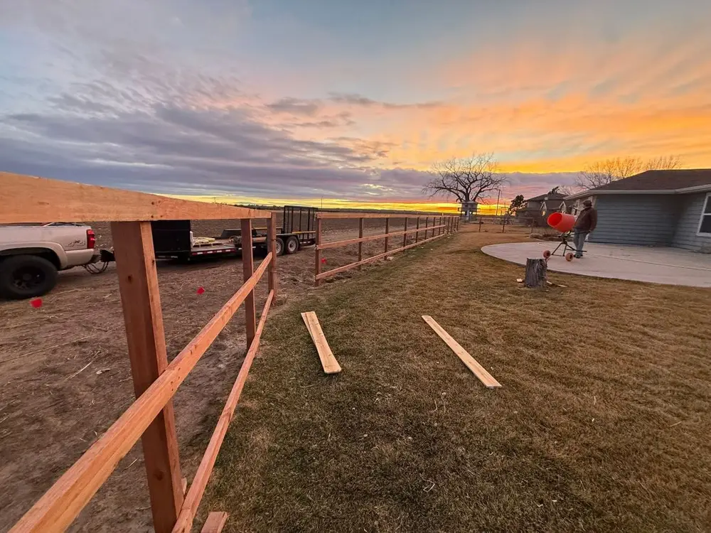 Rail fence going in at sunset