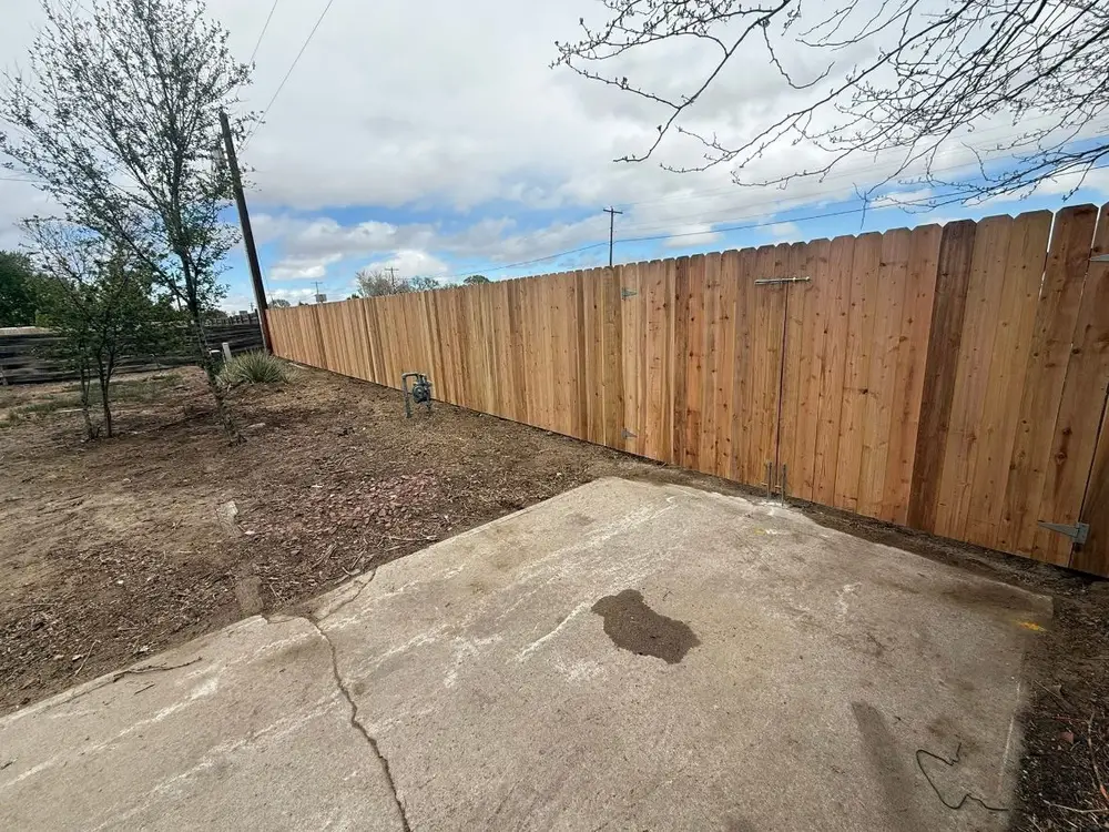 After: old chain-link fence, then a new wood privacy fence in the same yard