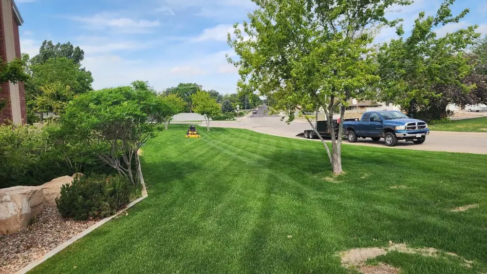 Levi's truck and trailer beside a striped commercial lawn